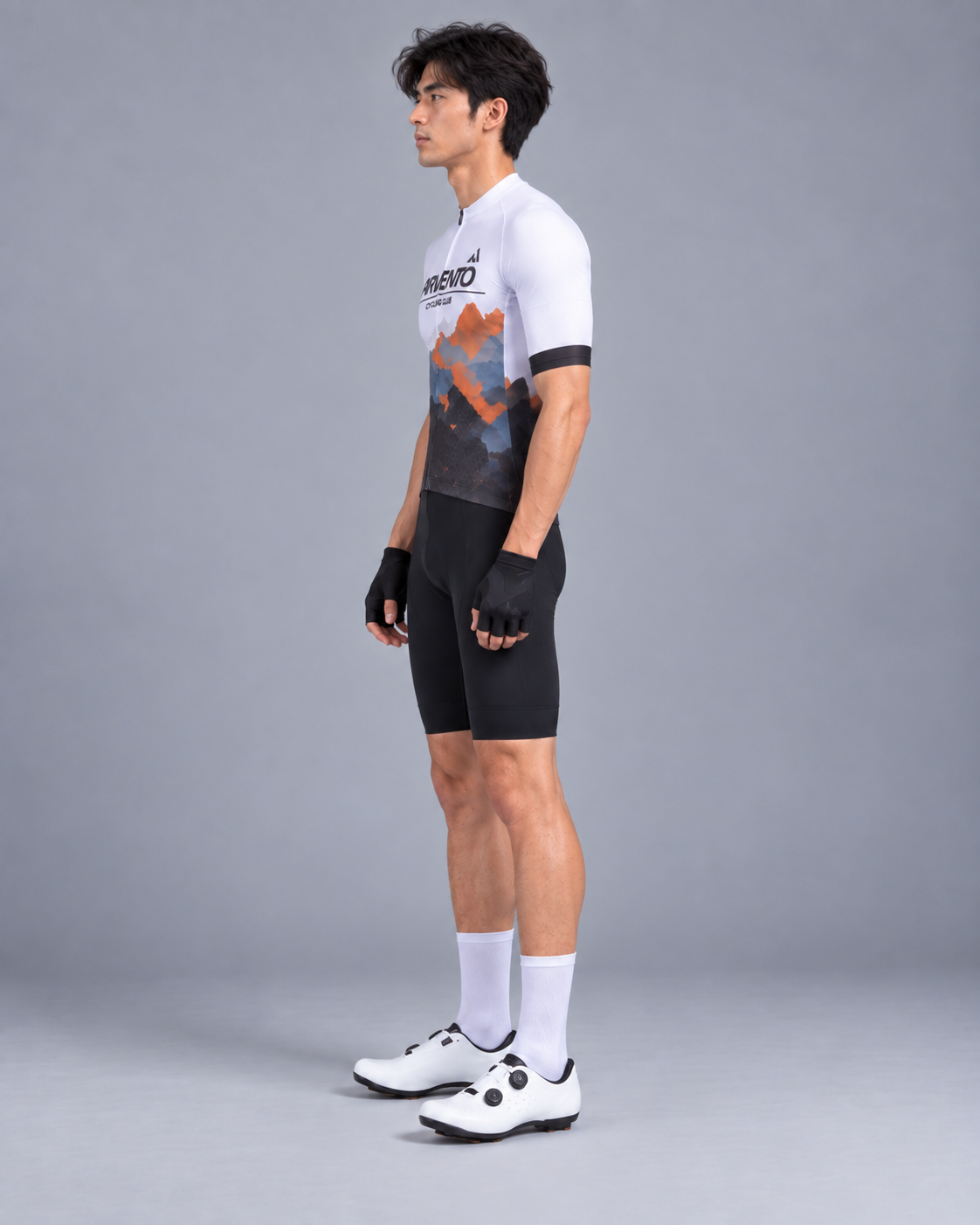 Side view of a Taiwanese male cyclist wearing the ARVENTO white mountain cycling jersey and black cycling bib shorts.