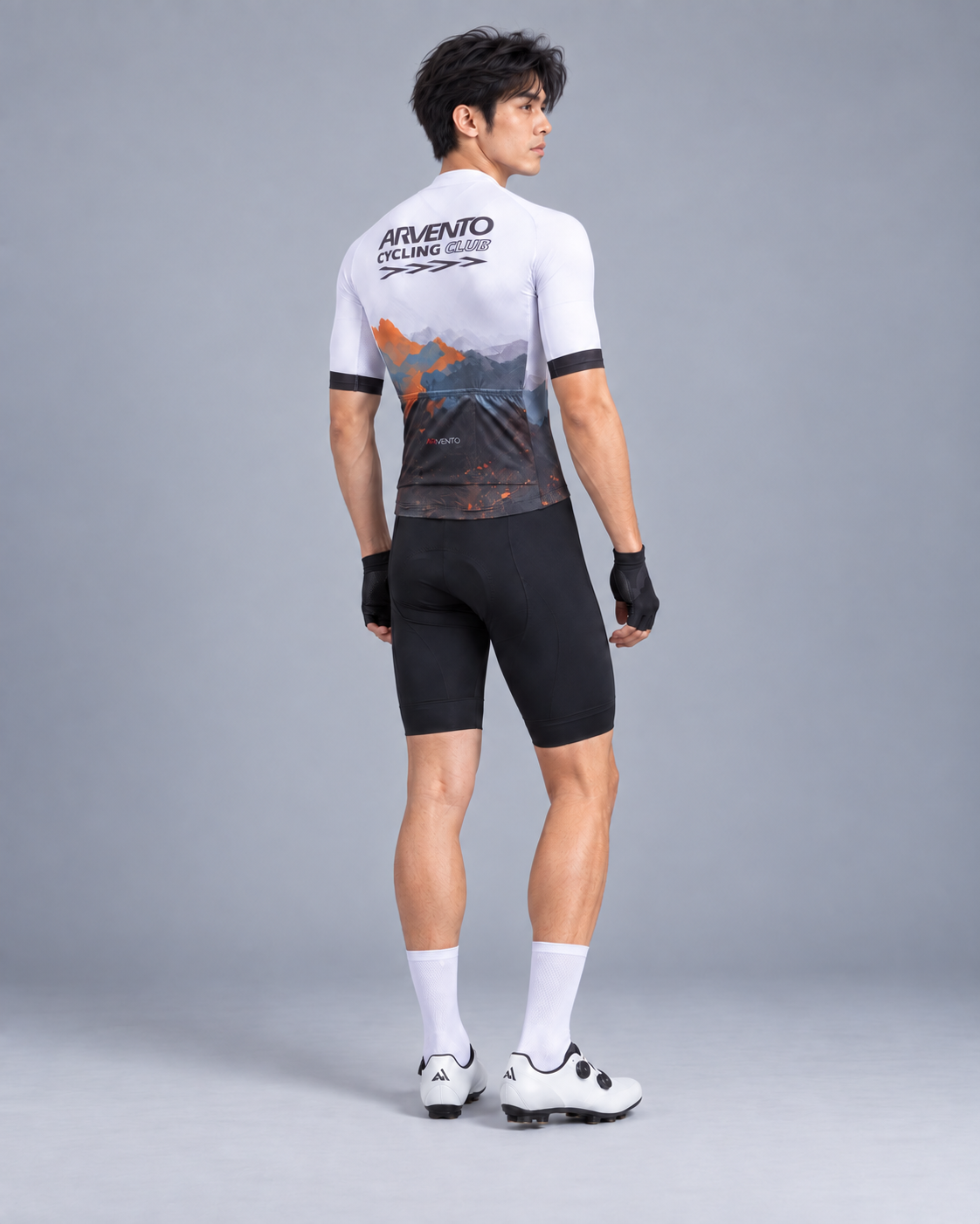 Side view of a Taiwanese male cyclist wearing the ARVENTO white mountain cycling jersey and black cycling bib shorts.