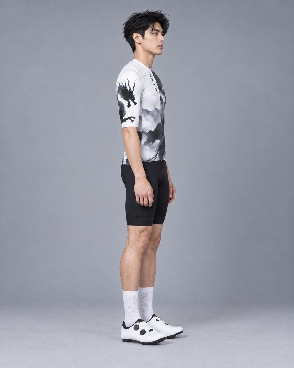 Full-body right side view of a Taiwanese male cyclist wearing the ARVENTO ink-wash cycling jersey.