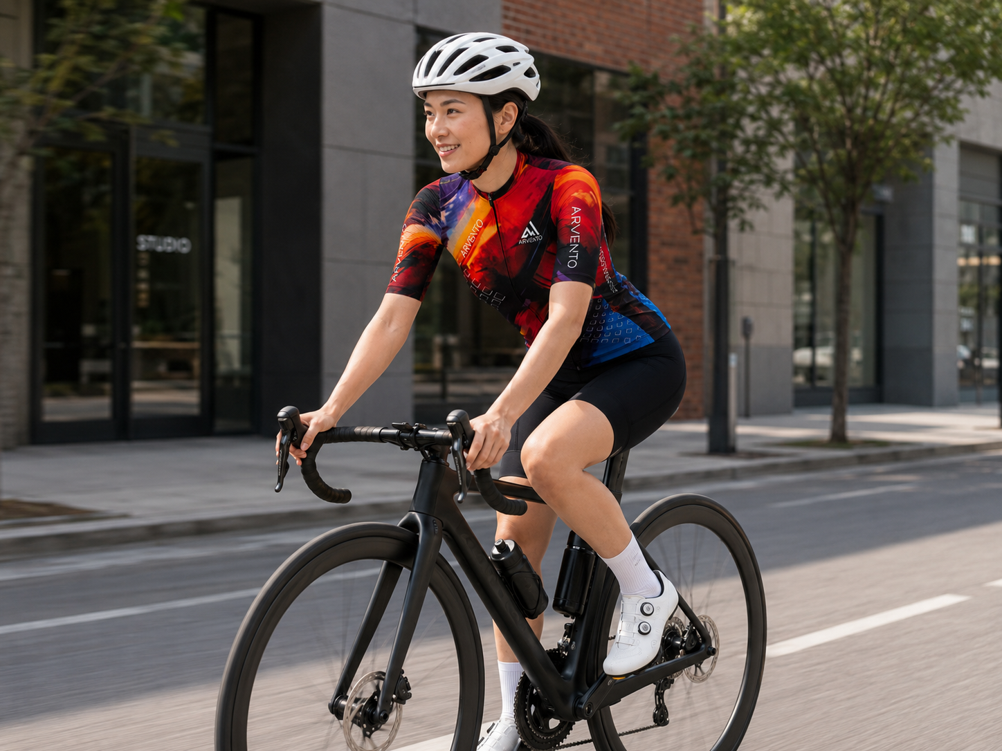 Female cyclist wearing the ARVENTO CB001 Abstract Brush cycling jersey.
